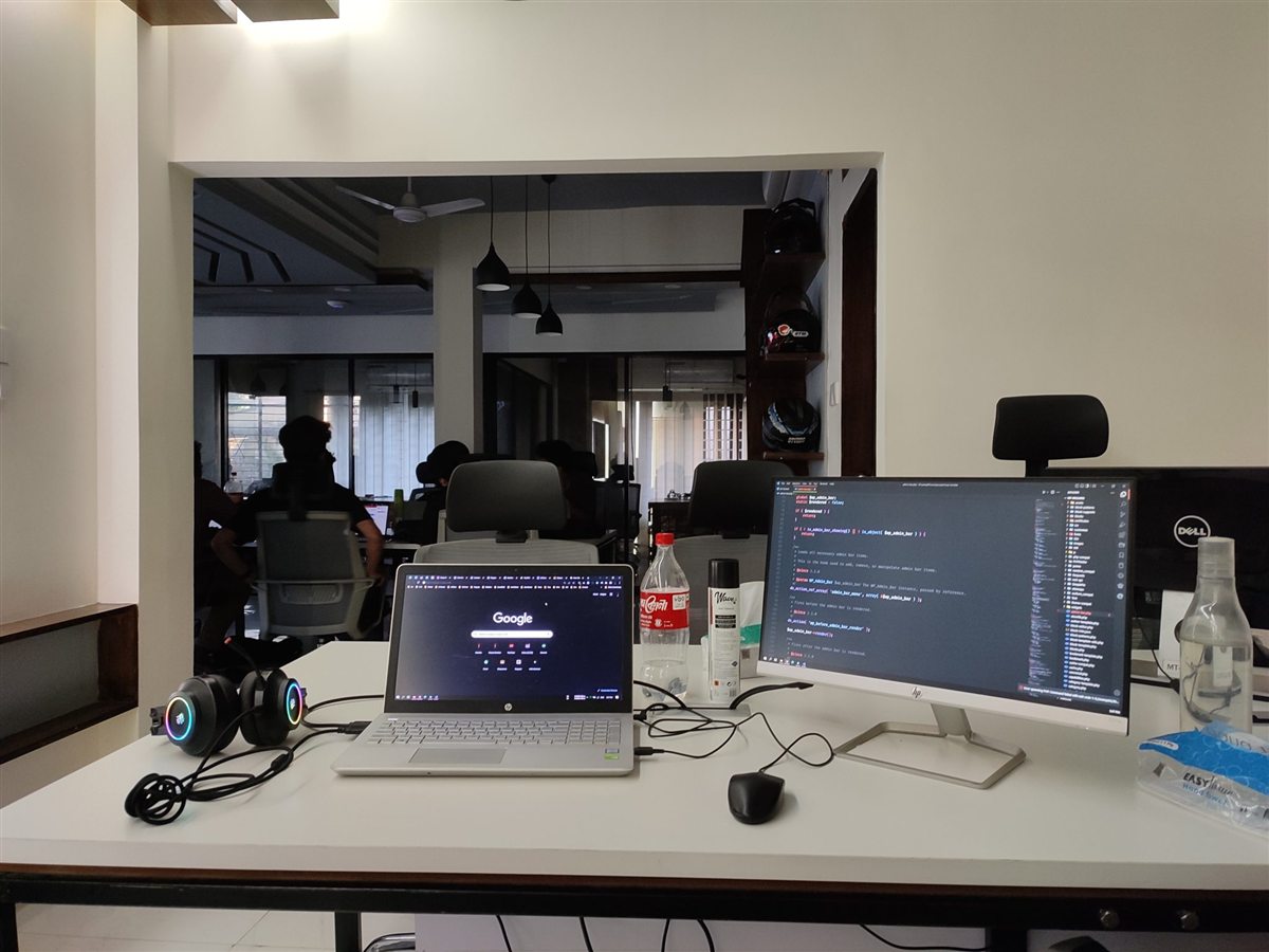 An office desk with a laptop and a second screen. An office desk with a laptop and a second screen.